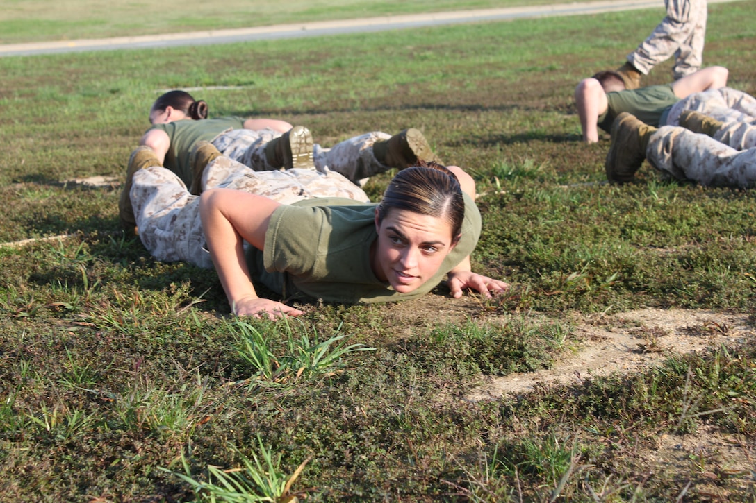 Lance Cpl. Vanessa Landeros, Manpower Managemenet Officer Assignment, is put in a choke hold during the Spartan Games at the CFC kick-off field meet.