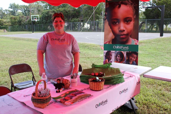 Sarah Gorman, Corporate Strategic Alliances Specialist, stands at the ChildFund International table at the CFC kick-off field meet, held aboard Marine Corps Base Quantico.