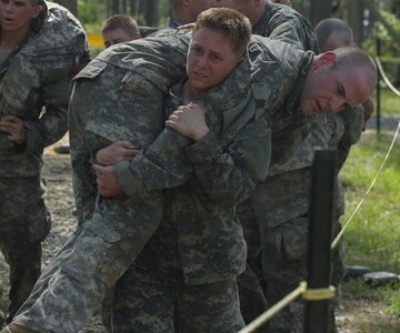 U.S. Army Soldiers conduct the Darby Queen obstacle course during the Ranger Course on Fort Benning, Ga., April 26, 2015. Soldiers attend the Ranger Course to learn additional leadership and small unit technical and tactical skills in a physically and mentally demanding combat simulated environment. (U.S. Army photo by Spc. Dacotah Lane/Released)