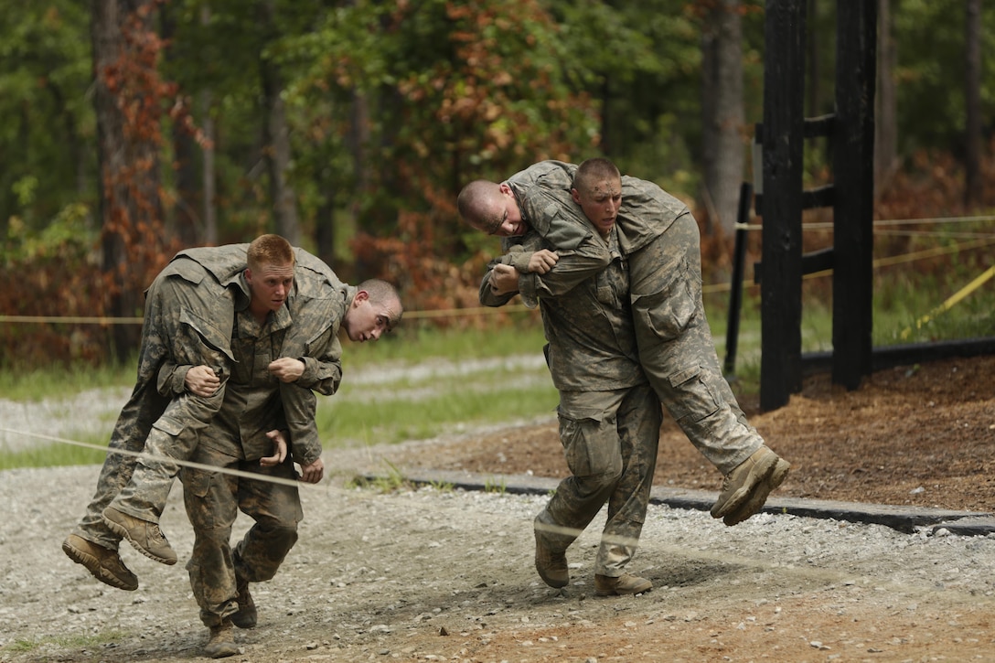 Maj. Lisa Jaster, an Army Reserve soldier, performs a fireman’s carry on a simulated casualty during the Ranger Course on Ft. Benning, GA. 