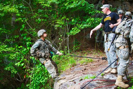 Maj. Lisa Jaster, an Army Reserve soldier, performs a fireman’s carry on a simulated casualty during the Ranger Course on Ft. Benning, GA. 