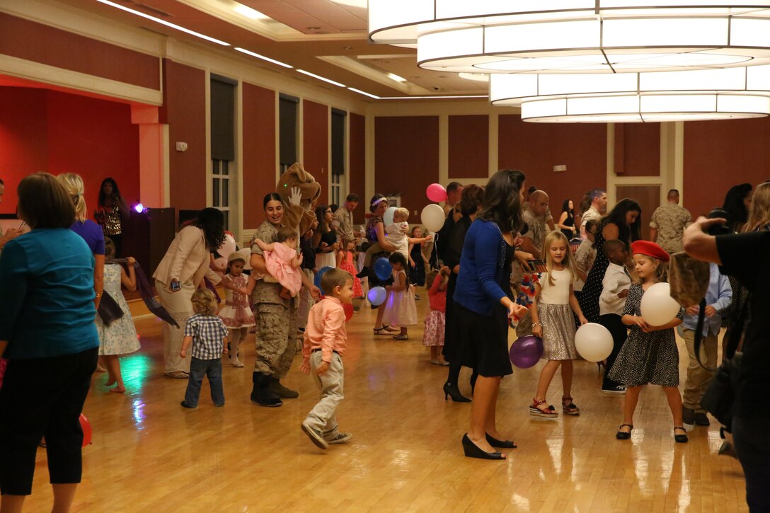 Marines and their family members with Marine Aircraft Group 26 dance together at the unit’s Children’s Ball aboard Camp Lejeune, N.C., Oct. 9, 2015. The MAG-26 Children’s Ball allowed Marines to share the traditions of the Marine Corps birthday with their families.
