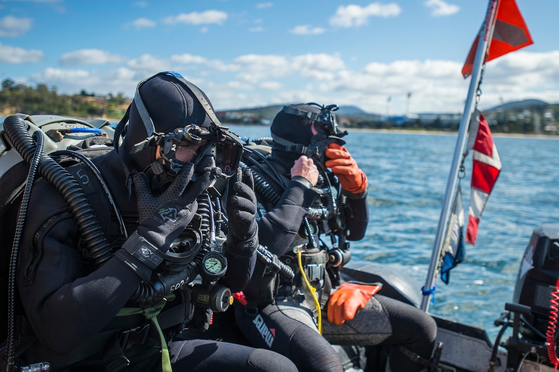 U.S. Navy Petty Officer 3rd Class Corey Barker, left, and Chief Petty Officer Matthew Wehr, perform pre-dive checks during exercise Dugong 2015 near Hobart, Australia, Oct. 7, 2015. Barker and Wehr are assigned to Explosive Ordnance Disposal Mobile Unit 5. U.S. Navy photo by Petty Officer 2nd Class Daniel Rolston