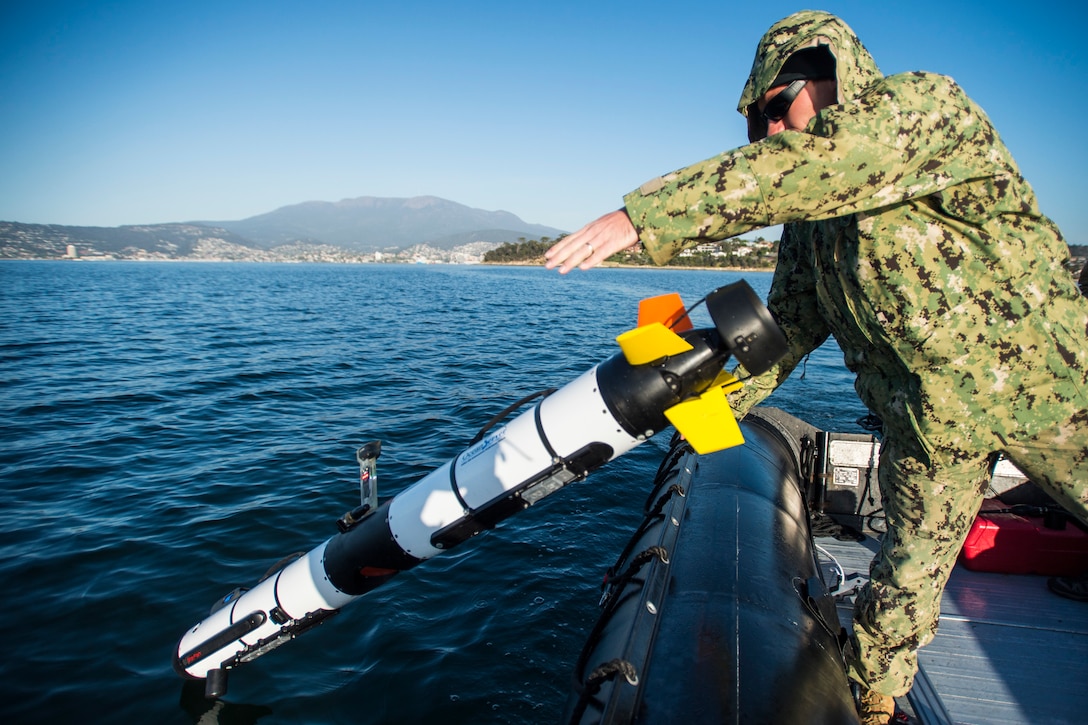 U.S. Navy Petty Officer 3rd Class Kaden Ross launches an unmanned underwater vehicle during exercise Dugong 2015 near Hobart, Australia, Oct. 7, 2015. Ross is assigned to Explosive Ordnance Disposal Mobile Unit 5. U.S. Navy photo by Petty Officer 2nd Class Daniel Rolston