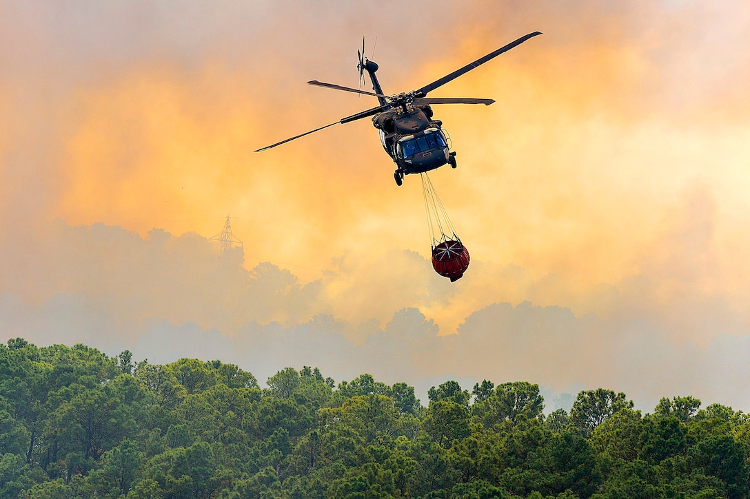 A Texas Army National Guard UH-60 Black Hawk helps fight wildfires threatening homes and property near Bastrop, Texas, Oct. 14, 2015. U.S. Army National Guard photo by Sgt. 1st Class Malcolm McClendon