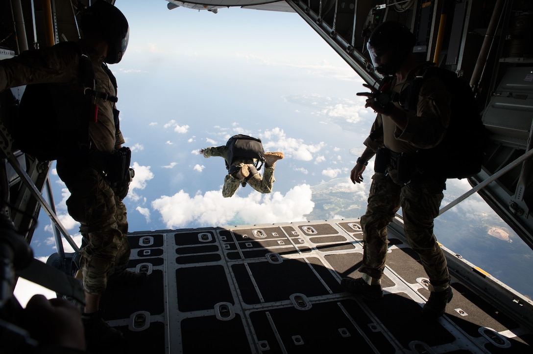 U.S. Navy sailors jump from a C-130 Hercules aircraft during military free fall jump sustainment training near Santa Rita, Guam, Oct. 14, 2015.  The sailors are assigned to Explosive Ordnance Disposal Mobile Unit 5. U.S. Navy photo by Petty Officer 1st Class Ace Rheaume