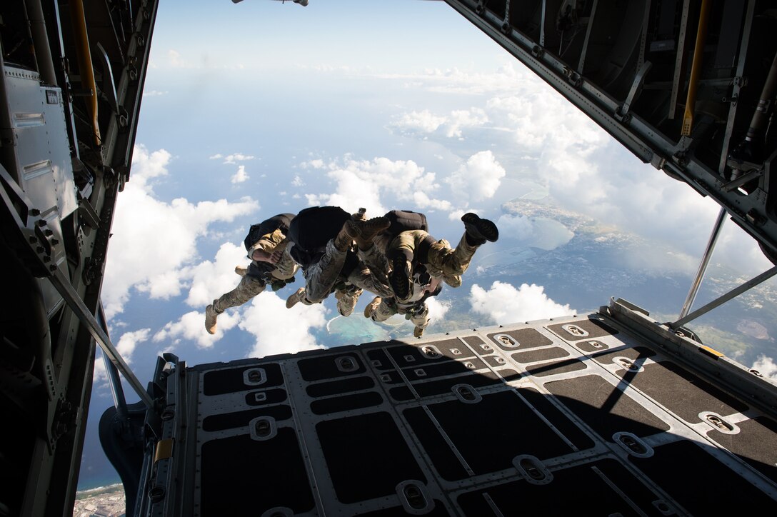 U.S. Navy sailors jump from a C-130 Hercules aircraft during military free fall jump sustainment training near Santa Rita, Guam, Oct. 14, 2015. U.S. Navy photo by Petty Officer 1st Class Ace Rheaume 