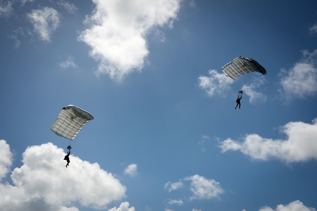 U.S. sailors approach a landing zone during military free fall jump sustainment training in Santa Rita, Guam, Oct. 14, 2015. U.S. Navy photo by Petty Officer 1st Class Ace Rheaume