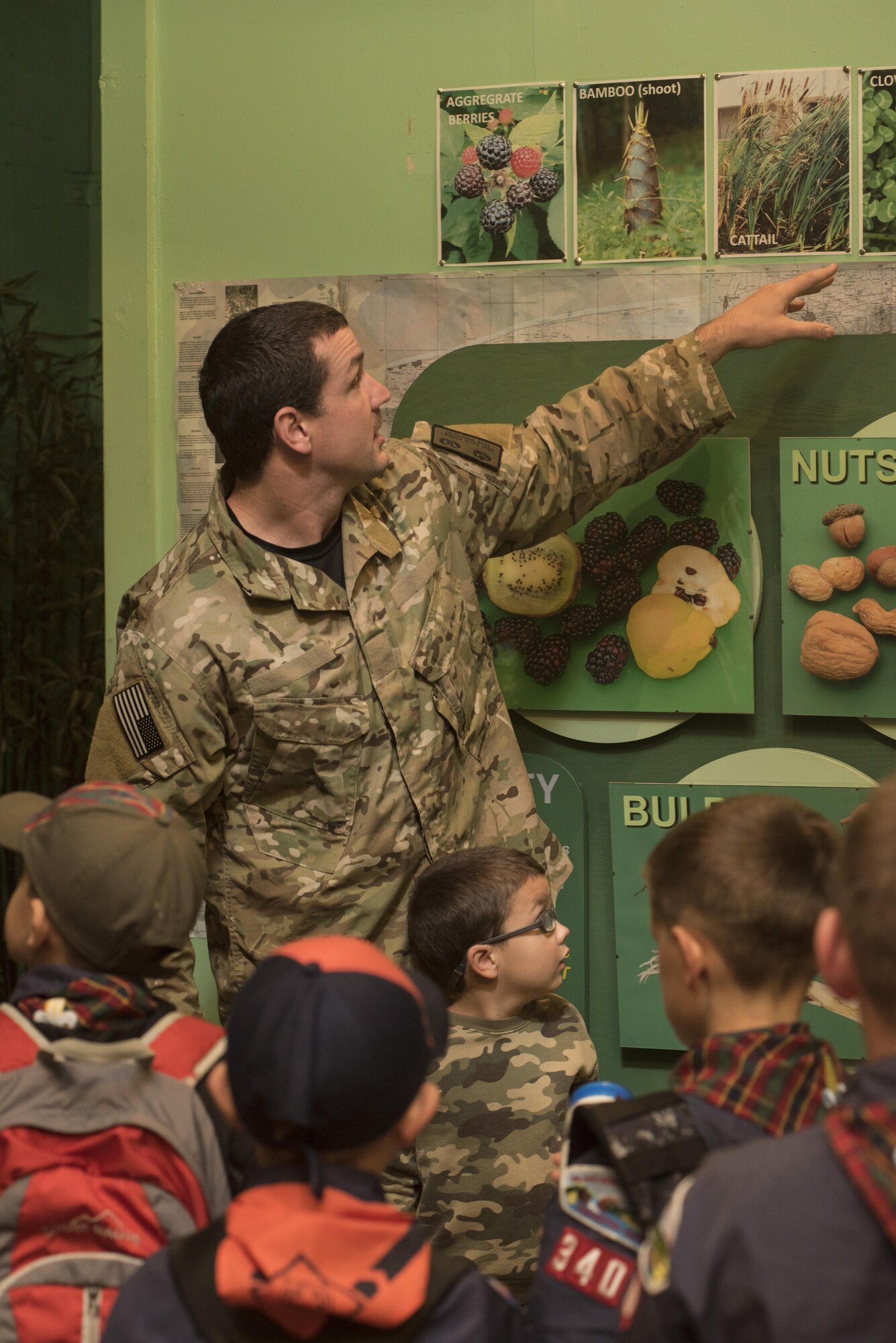 Staff Sgt. Keith Schmidt, 22nd Training Squadron Survival, Evasion, Resistance and Escape specialist, speaks with Cub Scouts from Pack 340 about different types of plants that are edible in the wilderness Oct. 9, 2015, at Fairchild Air Force Base, Wash. Some concerns while in the field are staying dry and repelling insects. (U.S. Air Force photo/Airman 1st Class Sean Campbell) 