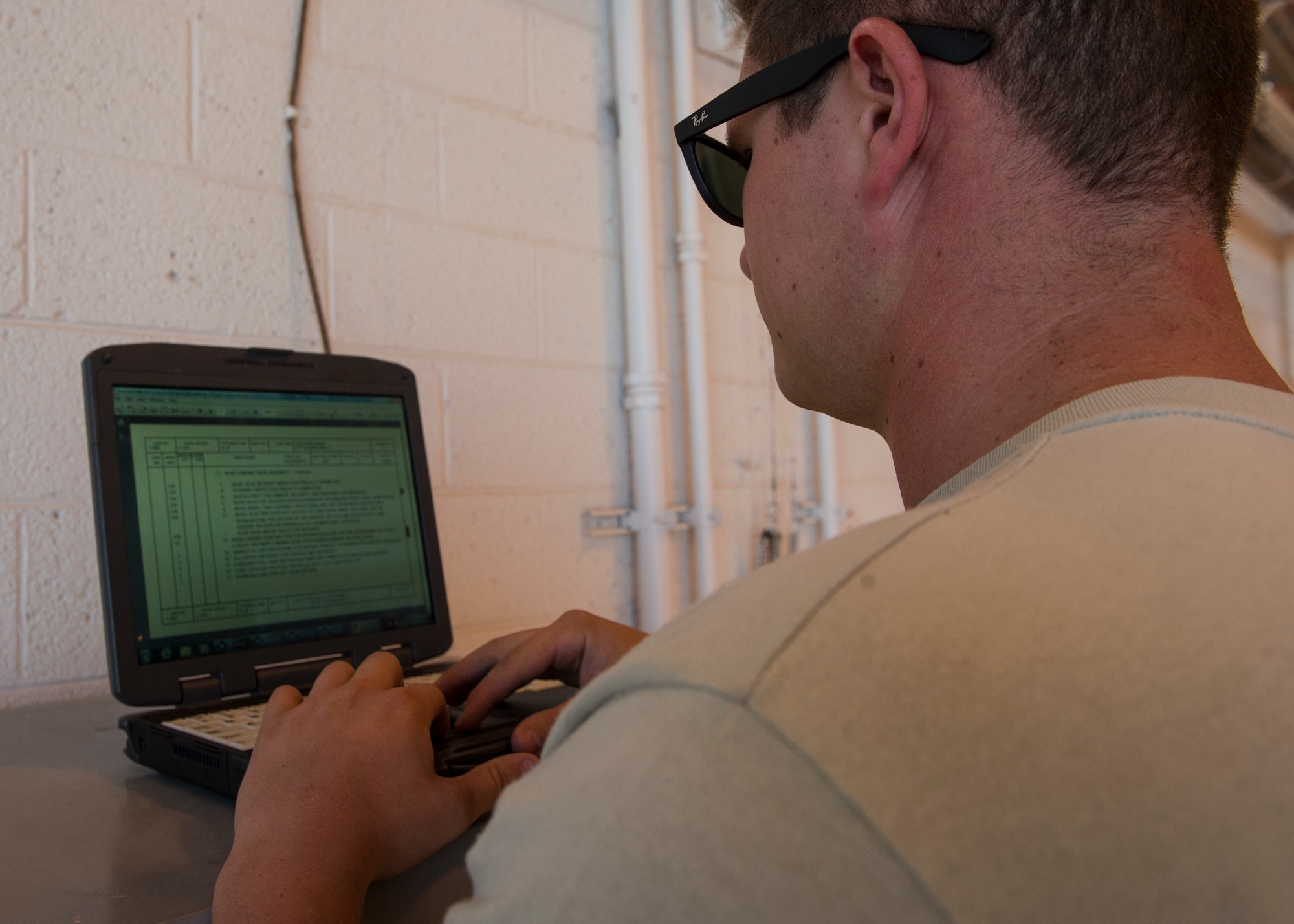 Senior Airman Daniel Hawley, an MQ-9 Reaper crew chief with the 49th Aircraft Maintenance Squadron, checks an electronic technical order prior to performing a pre-flight inspection at Holloman Air Force Base, N.M., Oct. 13, 2015. Electronic technical orders are manuals which provide step-by-step instructions for any maintenance required on a particular aircraft. (U.S. Air Force photo by Airman 1st Class Emily A. Kenney/Released)   