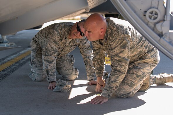 Air Force Col. Bradley Swanson, 153rd Airlift Wing commander and Lt. Col. Todd Davis, 153rd Aircraft Maintenance commander, look over the nose landing gear of a C-130H Hercules aircraft, tail number 1533, after it returned from maintenance at Hill Air Force Base, Utah. The aircraft landing gear was overhauled after a mechanical malfunction caused the aircrew to land with nose landing gear up while the aircraft was involved with fighting fires. (U.S. Air National Guard photo/Master Sgt. Charles Delano) 
