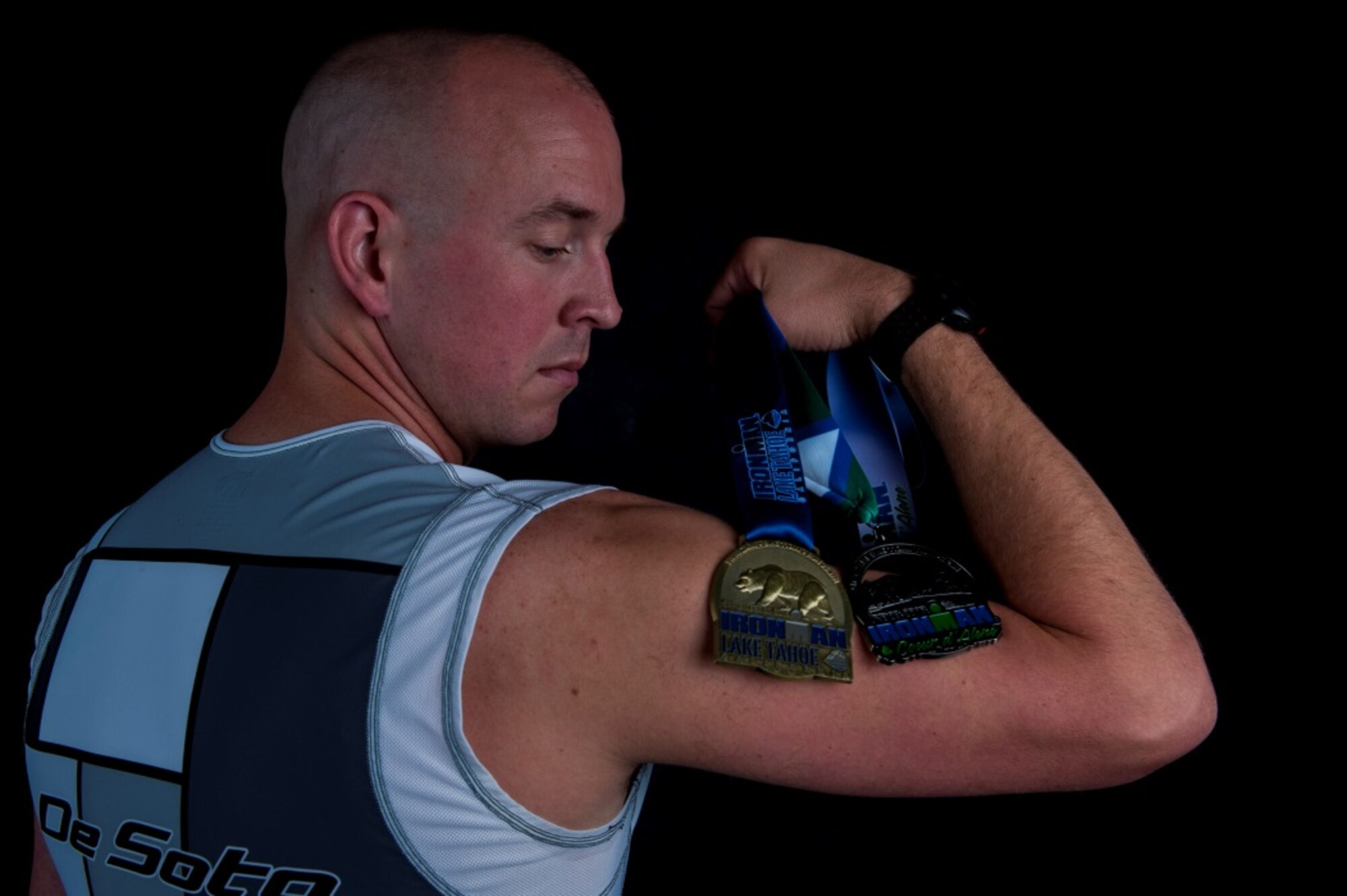 Staff Sgt. Josh Hull, NCO in charge of the Minot Air Force Base Honor Guard, poses with his Iron Man Challenge medals at Minot AFB, N.D., Oct. 13, 2015. Hull started running to grieve the loss of his younger brother. (U.S. Air Force photo/Airman 1st Class Christian Sullivan)