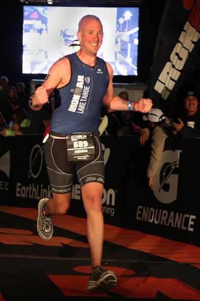 Staff Sgt. Josh Hull, NCO in charge of the Minot Air Force Base Honor Guard, crosses the finish line at the Iron Man Lake Tahoe 2015, Sep. 30, 2015. Hull completed two Iron Man Challenges in 2015, with a best finishing time of 14 hours, 27 minutes, 31 seconds. (Courtesy photo)