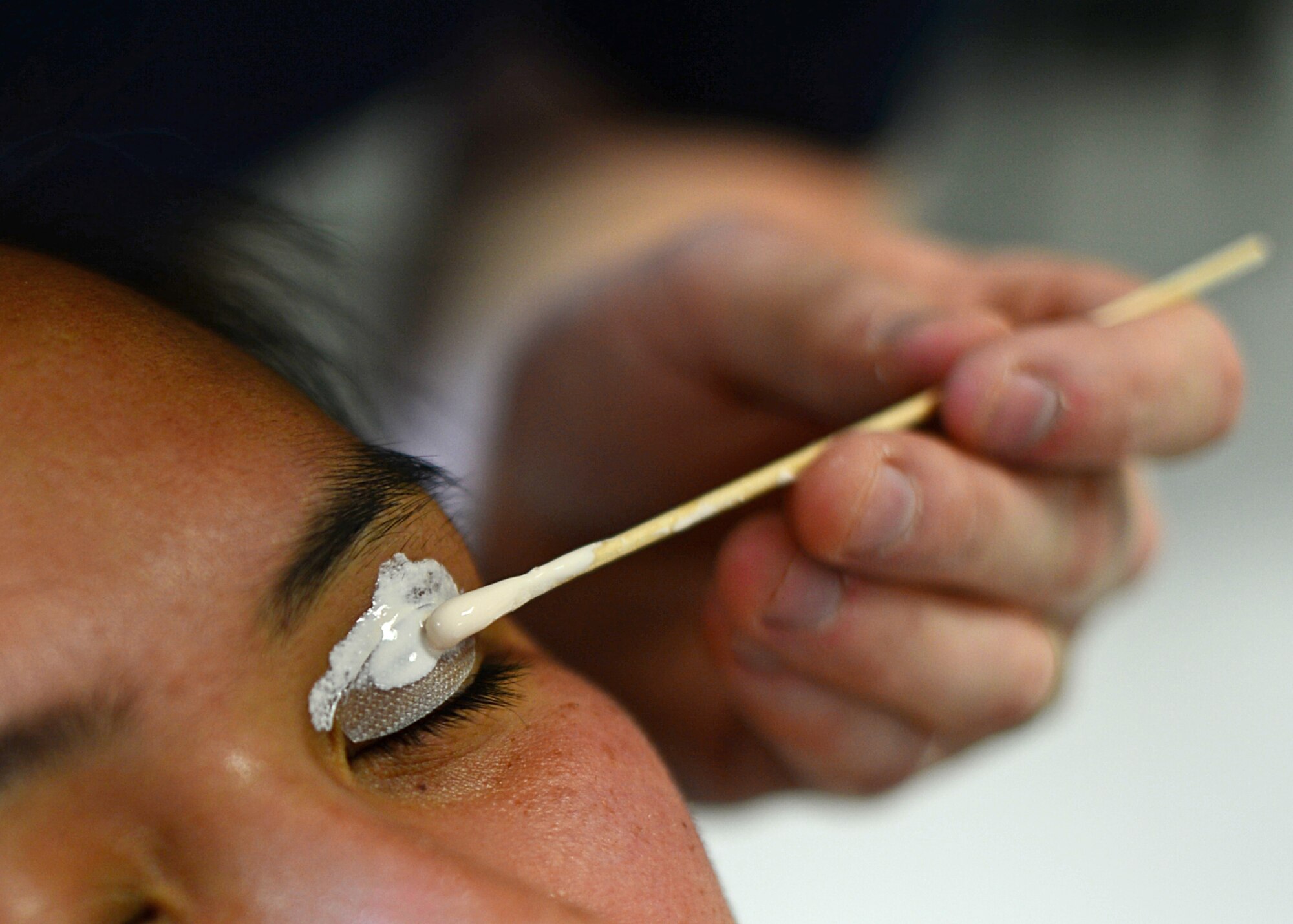 An active duty victim advocate has moulage makeup applied to simulate a black eye at Royal Air Force Lakenheath, England, Oct. 14, 2015. Victim advocate Airmen and spouses participated in Domestic Violence Awareness month by wearing black eyes to promote awareness and educate Airmen on how to assist victims of domestic violence. (U.S. Air Force photo by Senior Airman Erin O’Shea/Released)