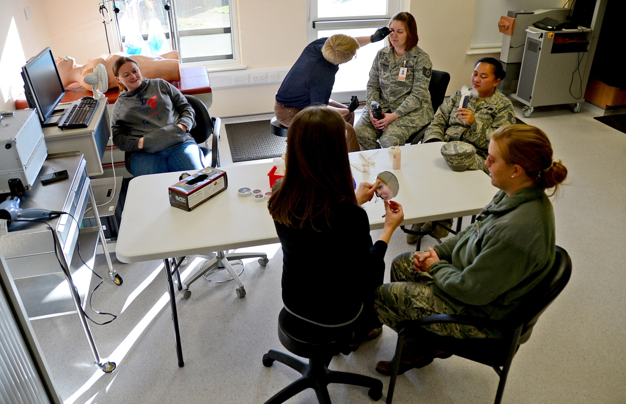 Active-duty victim advocates, along with a victim advocate spouse, have moulage makeup applied to simulate black eyes at Royal Air Force Lakenheath, England, Oct. 14, 2015. Participants wore the makeup to work and around base for two hours to raise awareness about  domestic violence and to educate Airmen on how to assist victims. (U.S. Air Force photo by Senior Airman Erin O’Shea/Released) 