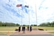 U.S. Service members with the RAF Molesworth Joint Honor Guard stand at parade rest before lowering the American and RAF Ensign flags, during a retreat ceremony at RAF Molesworth, United Kingdom, June 5, 2015. The newly-reconstructed honor guard team consists of U.S. Army, Marine Corps, Navy and Air Force personnel who showcase the American flag throughout England and other countries, such as Germany. (U.S. Air Force photo by Staff Sgt. Ashley Hawkins/Released)