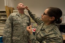 U.S. Air Force Col. Joe McFall, 52nd Fighter Wing commander, receives his flu mist from U.S. Air Force Staff Sgt. Jaryl Burjoss, 52nd Medical Operations Squadron allergy immunization technician at the 52nd Medical Group at Spangdahlem Air Base, Germany, Oct. 7, 2015. The flu virus strain can change; Administering the influenza vaccine yearly ensures Spangdahlem community receives the most up-to-date vaccine, since the flu virus train changes every year. (U.S. Air Force photo by Staff Sgt. Christopher Ruano/Released)