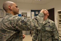 U.S. Air Force Chief Master Sgt. Brian Gates, 52nd Fighter Wing command chief, receives his flu mist from Senior Airman Erick Diaz, 52nd Medical Operations Squadron family health technician at the 52nd Medical Group at Spangdahlem Air Base, Germany, Oct. 7, 2015. The public health office will conduct a medical exercise Oct. 21 to demonstrate the wing's capability to service the base population in the event of a disease threat or outbreak as efficiently as possible. (U.S. Air Force photo by Staff Sgt. Christopher Ruano/Released)