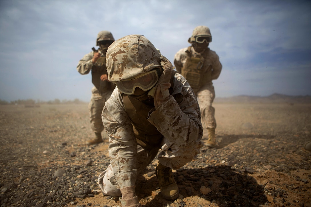 Marines brace for rotor wash during an assault support tactics exercise on Landing Zone Bull, Chocolate Mountain Aerial Gunnery Range, Calif., Oct. 12, 2015. The exercise was part of a seven week training event hosted by Marine Aviation Weapons and Tactics Squadron One. U.S. Marine Corps photo by Lance Cpl. Roderick L. Jacquote