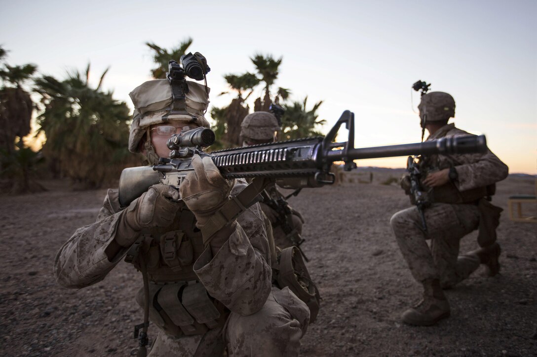 U.S. Marine Corps Lance Cpl. Manning William provides security during a heavy huey raid at K-9 Village, Yuma Proving Grounds, Yuma, Ariz., Oct. 7, 2015. The exercise was part of Weapons and Tactics Instructor 1-16 training hosted by Marine Aviation Weapons and Tactics Squadron One.  U.S. Marine Corps photo by Lance Cpl. Roderick L. Jacquote 