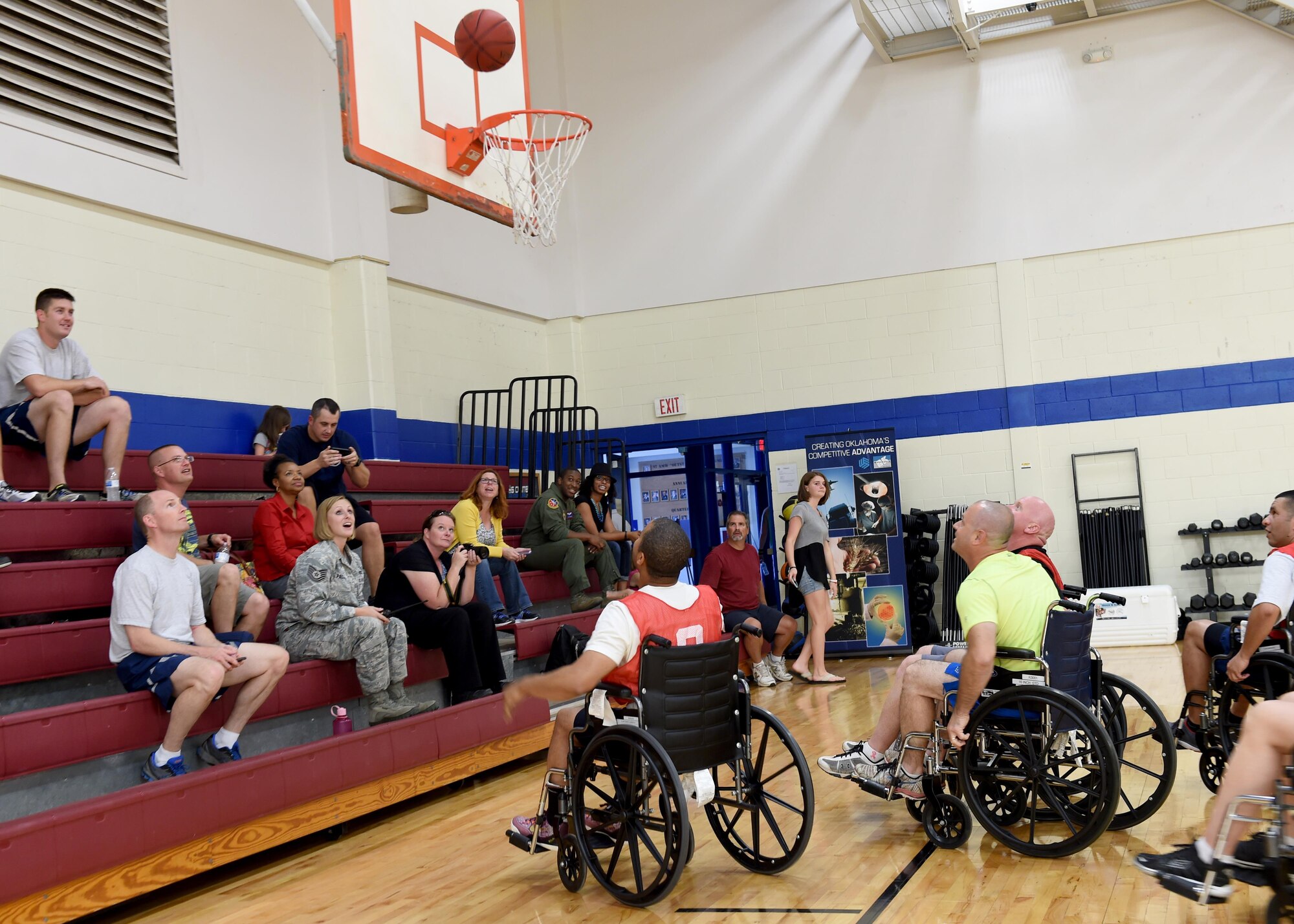 ALTUS AIR FORCE BASE, Okla. – Commanders, chief master sergeants and first sergeant participate in a game of wheelchair basketball at the base fitness center, Oct. 14, 2015. The game was held to raise awareness for National Disabled Employment Awareness Month. This year marks the 25th anniversary since the American Disabilities Act was passed by congress.  (U.S. Air Force photo by Airman 1st Class Kirby Turbak/Released)