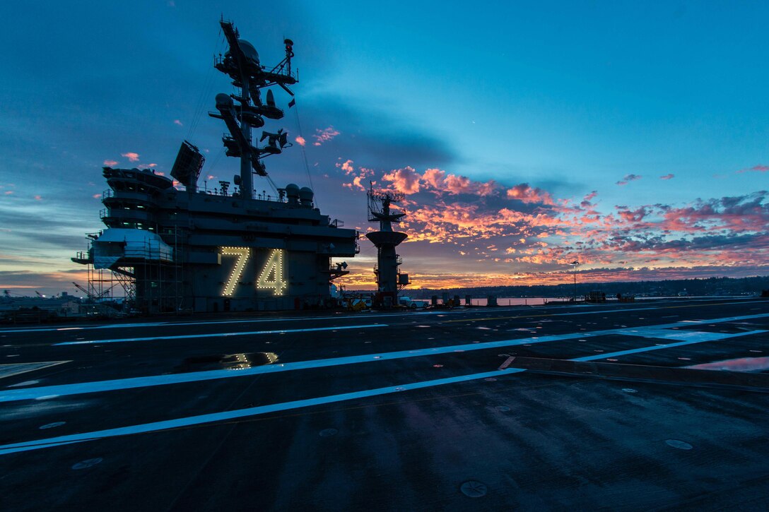 The sun rises over the aircraft carrier USS John C. Stennis at Naval Base Kitsap-Bremerton, Wash., Oct. 9, 2015. The Stennis is preparing for future deployments. U.S. Navy photo by Petty Officer 3rd Class Andre T. Richard
