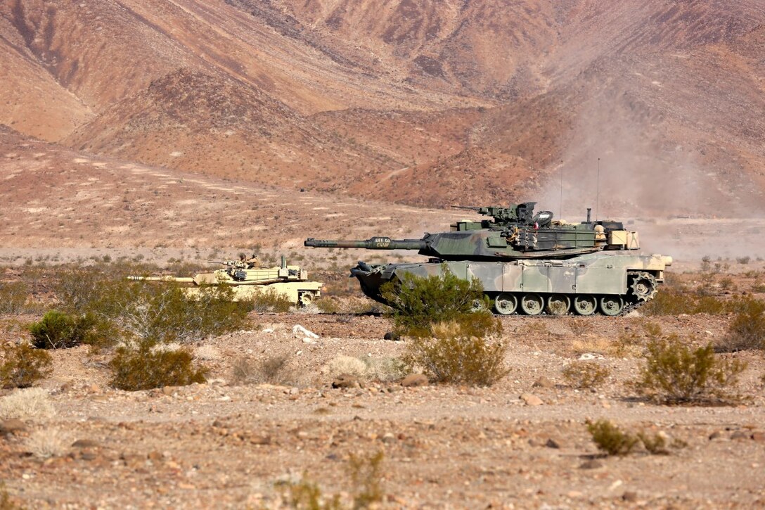M1A1 Main Battle Tanks with Company A, 1st Tank Battalion, 1st Marine Division align themselves in order to provide fire support for British Royal Marines with 42 Commando Group during Exercise Black Alligator 2015 aboard Marine Air Ground Combat Center Twentynine Palms, Calif., Sept. 30, 2015. The exercise gave 1st Tanks an opportunity to hone and showcase their support capabilities, while building upon an already established relationship with the Royal Marines.     (U.S.Marine Corps photo by Cpl. Demetrius Morgan/RELEASED)