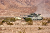 M1A1 Main Battle Tanks with Company A, 1st Tank Battalion, 1st Marine Division align themselves in order to provide fire support for British Royal Marines with 42 Commando Group during Exercise Black Alligator 2015 aboard Marine Air Ground Combat Center Twentynine Palms, Calif., Sept. 30, 2015. The exercise gave 1st Tanks an opportunity to hone and showcase their support capabilities, while building upon an already established relationship with the Royal Marines.     (U.S.Marine Corps photo by Cpl. Demetrius Morgan/RELEASED)