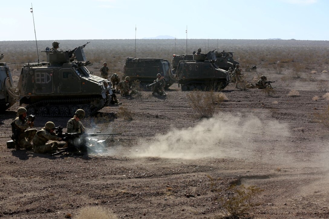 British Royal Marines with 42 Commando Group provide suppressive fire on an objective during Exercise Black Alligator 2015 aboard Marine Air Ground Combat Center Twentynine Palms, Calif., Sept. 30, 2015. The joint exercise allowed the British to employ Company A, 1st Tank Battalion, 1st Marine Division, integrating them into their own scheme of maneuver to engage a variety of targets.    (U.S.Marine Corps photo by Cpl. Demetrius Morgan/RELEASED)
