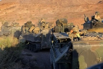 British Royal Marines with 42 Commando Group ride in amphibious assault vehicles with 3rd Assault Amphibian Battalion, 1st Marine Division during Exercise Black Alligator 2015 aboard Marine Air Ground Combat Center Twentynine Palms, Calif., Oct. 1, 2015. The joint exercise allowed the British to employ 3rd AA Bn., integrating them into their own scheme of maneuver to transport ground forces.     (U.S.Marine Corps photo by Cpl. Demetrius Morgan/RELEASED)