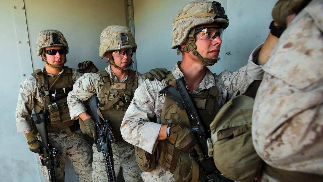 Marines assigned to the Urban Leaders Course at 1st Marine Division Schools, I Marine Expeditionary Force, prepare to clear a building during a live-fire training exercise aboard Marine Corps Base Camp Pendleton, Calif., Sept. 25, 2015. The class teaches fire team and squad leaders skills and tactics to be successful in urban environments, which they can share with the Marines they lead and the leadership of their entire unit. 