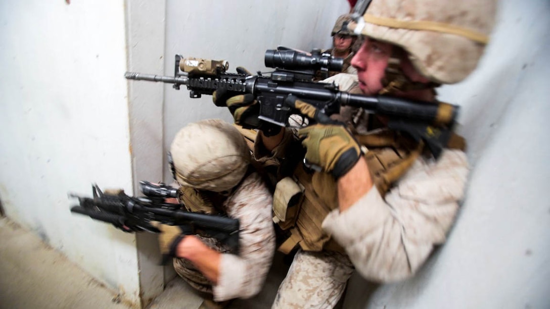 Marines assigned to the Urban Leaders Course at 1st Marine Division Schools, I Marine Expeditionary Force, clear a hallway during a live-fire training exercise aboard Marine Corps Base Camp Pendleton, Calif., Sept. 25, 2015. The class teaches fire team and squad leaders skills and tactics to be successful in urban environments, which they can share with the Marines they lead and the leadership of their entire unit. 