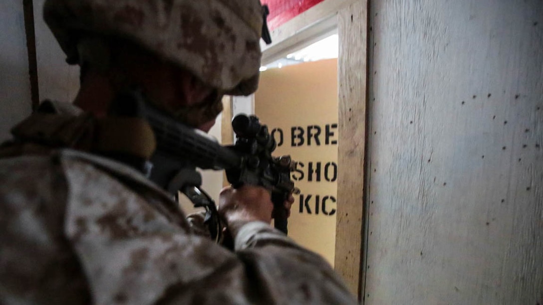 A Marine assigned to the Urban Leaders Course at 1st Marine Division Schools, I Marine Expeditionary Force, clears a room during a live-fire training exercise aboard Marine Corps Base Camp Pendleton, Calif., Sept. 25, 2015. The class teaches fire team and squad leaders skills and tactics to be successful in urban environments, which they can share with the Marines they lead and the leadership of their entire unit. 