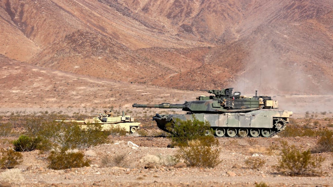 M1A1 Main Battle Tanks with Company A, 1st Tank Battalion, 1st Marine Division align themselves in order to provide fire support for British Royal Marines with 42 Commando Group during Exercise Black Alligator 2015 aboard Marine Air Ground Combat Center Twentynine Palms, Calif., Sept. 30, 2015. The exercise gave 1st Tanks an opportunity to hone and showcase their support capabilities, while building upon an already established relationship with the Royal Marines.     