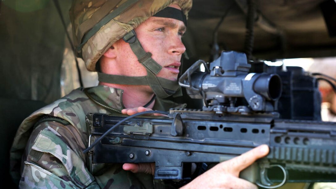Captain Paul King, the officer liaison with 42 Commando Group, British Royal Marines, observes long range targets from a HUMVEE during Exercise Black Alligator 2015 aboard Marine Air Ground Combat Center Twentynine Palms, Calif., Sept. 30, 2015. The joint exercise allowed the British to employ Company A, 1st Tank Battalion, 1st Marine Division, integrating them into their own scheme of maneuver to engage a variety of different targets. 