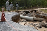 North Carolina National Guard Soldiers, assigned to the 882nd Engineers Company (Vertical), 505th Engineers Battalion, assess the damage of a road in Eastover, South Carolina, Oct. 13, 2015.