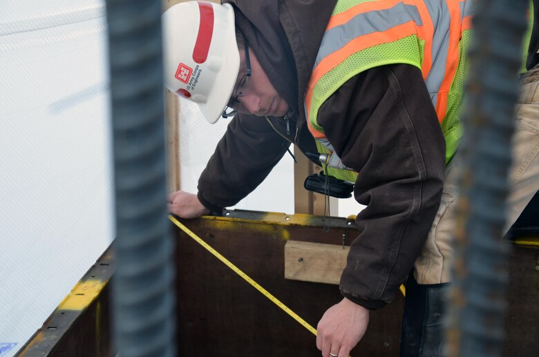 Jason Johns, engineering and construction, takes measurements at the Tolna Coulee project, near Tolna,
N.D., Jan. 18. Johns has worked on the project as a quality assurance representative since the beginning,
which was October 2011. The project is scheduled to be finished sometime in early April.