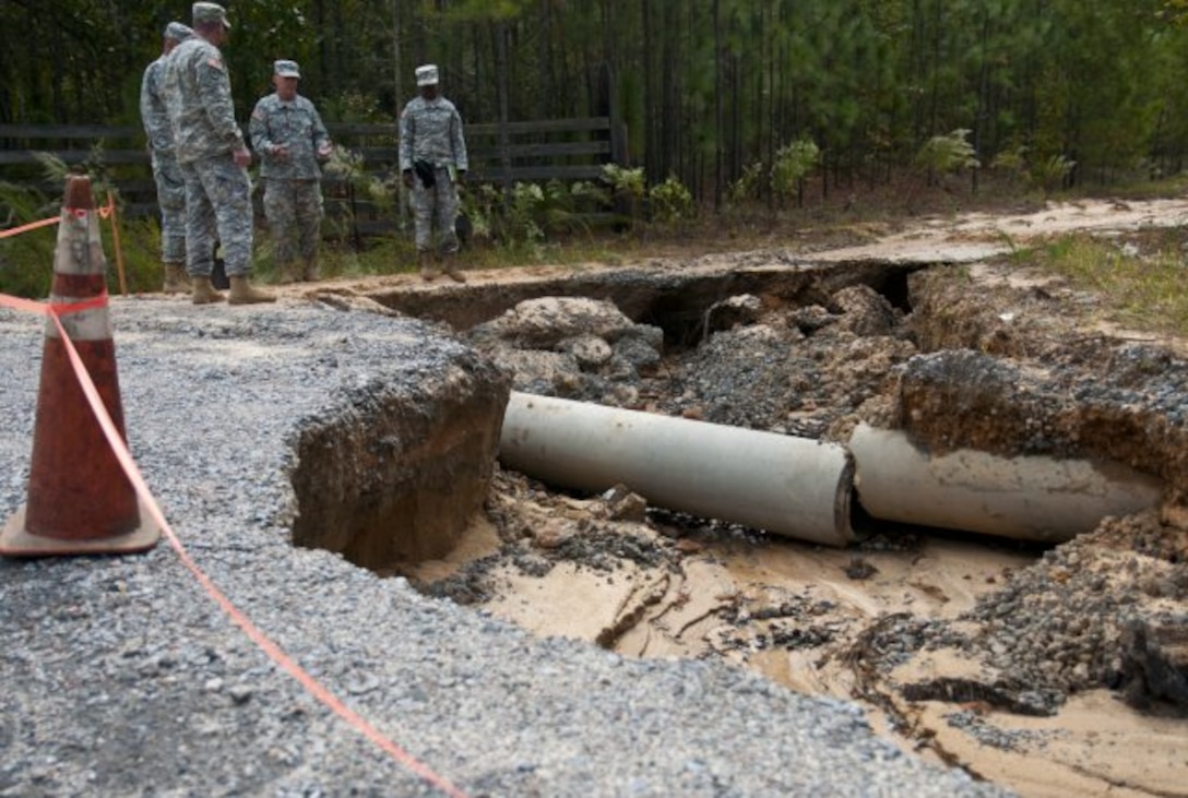 North Carolina National Guardsmen assigned to the 505th Engineer Battalion’s 882nd Engineer Company, assess the damage to a road in Eastover, S.C., Oct. 13, 2015. North Carolina Army National Guard photo by Sgt. Brian Godette 