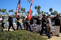 Marines and veterans stand as the 1st Marine Division color guard marches in during Park Semper Fi’s 10th anniversary ceremony at San Clemente, Calif., Oct. 11, 2015. Park Semper Fi was built to pay tribute to the Corps' honor, courage and commitment in service to the United States.