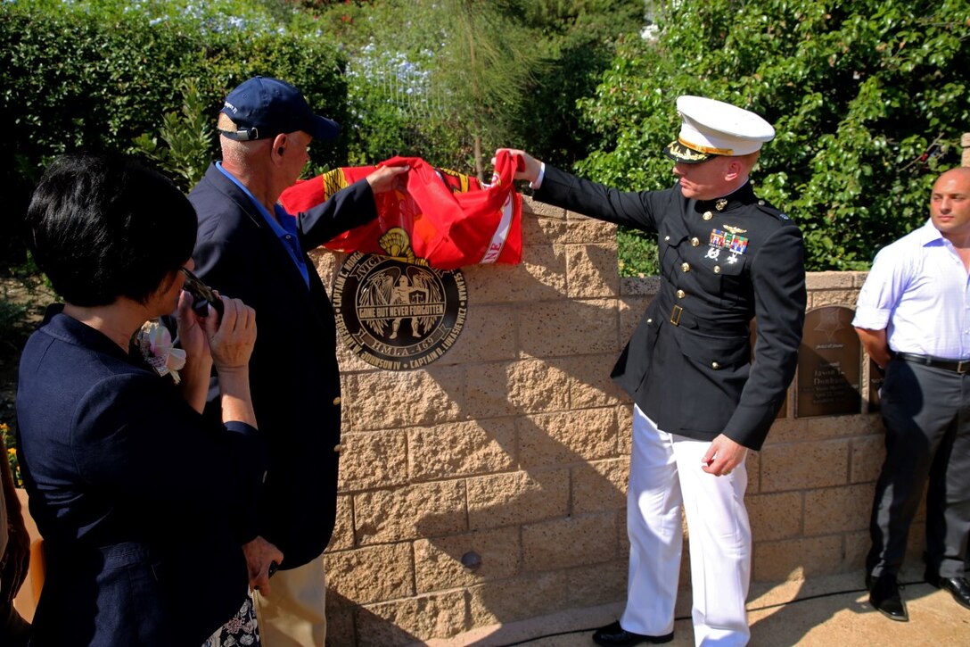 Lieutenant Col. Edward W. Powers, commanding officer of Marine Light Attack Helicopter Squadron 469, 3rd Marine Aircraft Wing, unveils the HMLA 469 memorial during Park Semper Fi’s 10th anniversary ceremony at San Clemente, Calif., Oct. 11, 2015. The ceremony paid tribute to Marines with HMLA 469 who gave their lives during a humanitarian mission in Nepal, May 12, 2015.