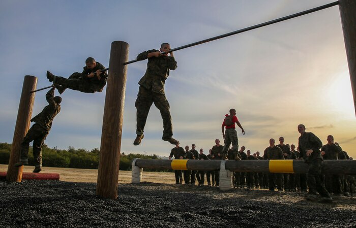 Recruits of Alpha Company, 1st Recruit Training Battalion, maneuver over a high bar during Obstacle Course II at Marine Corps Recruit Depot San Diego, Oct. 8. The recruits were taught various techniques to assist them in completing the obstacle. The obstacle course tested the recruits’ upper and lower body strength. Today, all males recruited west of the Mississippi are trained at MCRD San Diego. The depot is responsible for training more than 16,000 recruits annually. Alpha Company is scheduled to graduate Dec. 18.