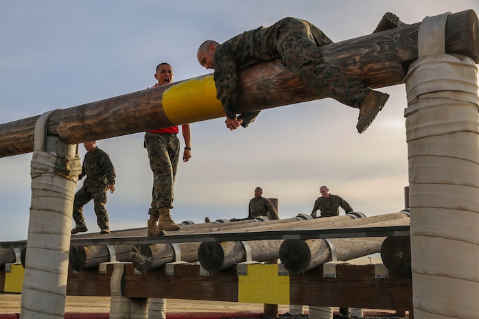 A recruit of Alpha Company, 1st Recruit Training Battalion, maneuvers over a high log during Obstacle Course II at Marine Corps Recruit Depot San Diego, Oct. 8. The course tested the recruits’ confidence, especially since many of the obstacles were high above the ground. Today, all males recruited west of the Mississippi are trained at MCRD San Diego. The depot is responsible for training more than 16,000 recruits annually. Alpha Company is scheduled to graduate Dec. 18.