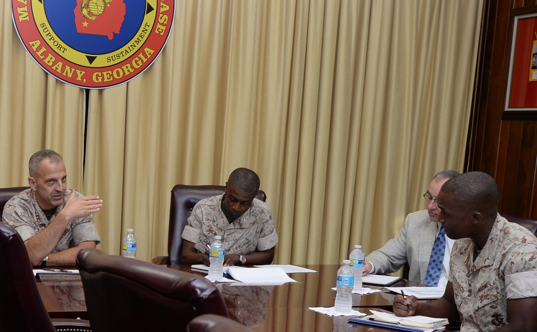 Lt. Gen. Michael G. Dana, (left) deputy commandant, Marine Corps Installations and Logistics, speaks with base officials after a brief, Oct. 14, at Marine Corps Logistics Base Albany.