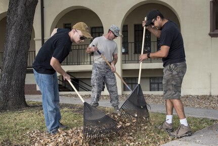 Tech. Sgt. Chuck Blades, Master Sgt. Eddie Martin and Master Sgt. Rick Mireles, Air Education and Training Command Studies Analysis Squadron aircraft systems test managers, rake leaves at the AETC headquarters building during Joint Base San Antonio Proud Week Oct. 7, 2015, at JBSA-Randolph. Proud Week gives JBSA members an opportunity to pause from daily operations and focus on maintaining a high beautification standard throughout JBSA.