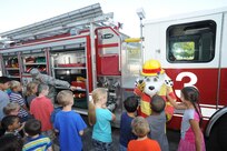 Staff Sgt. Erik Chittick, 502nd Civil Engineer Squadron firefighter, and Sparky the fire dog show Joint Base San Antonio-Randolph Elementary School children a fire truck Oct. 9 during National Fire Prevention Week. Fire Prevention Week was established to commemorate the Great Chicago Fire, and promoting fire safety and prevention.
Photo by Melissa Peterson
