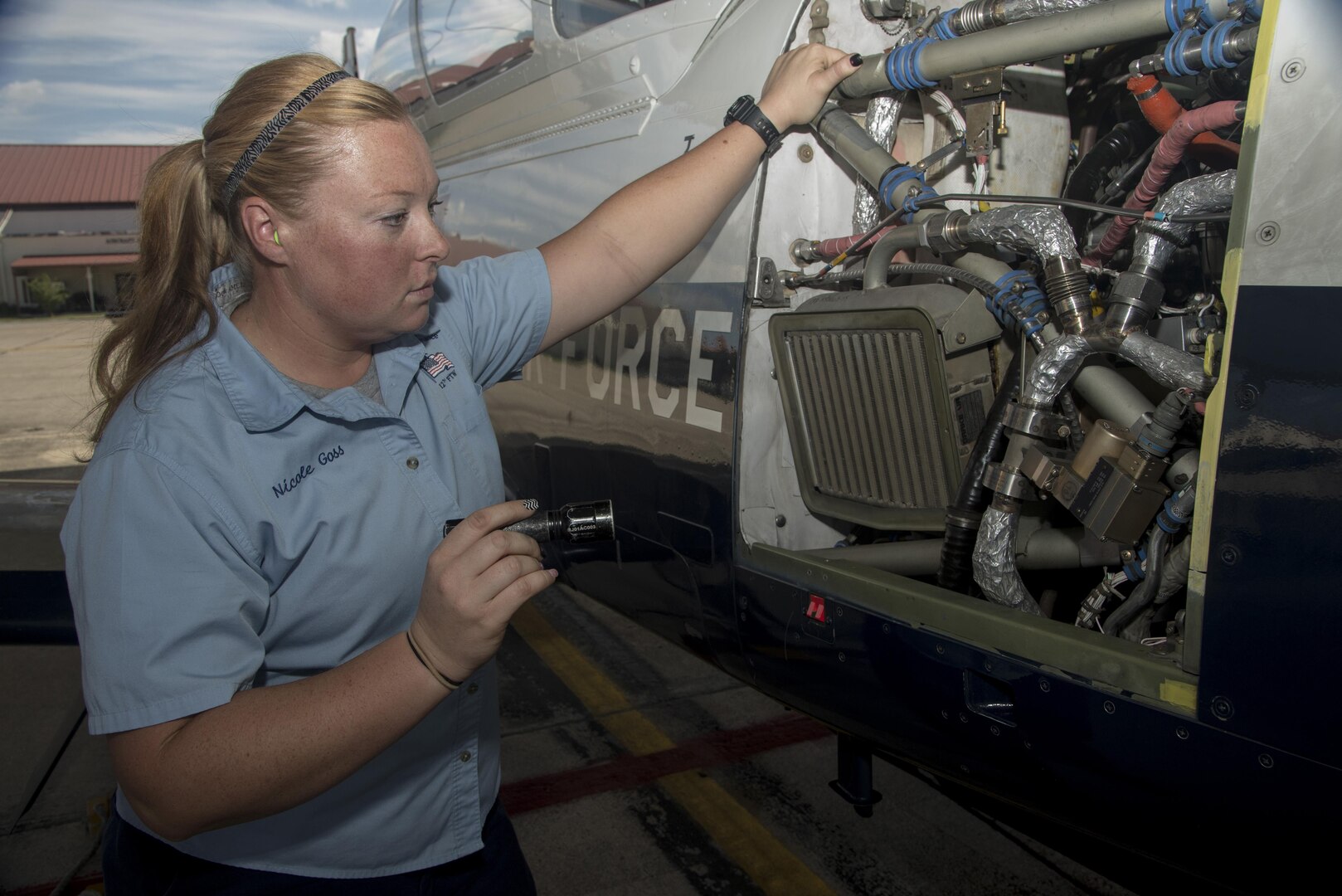 Nicole Goss, 12th Flying Training Wing Maintenance Directorate crew chief, inspects a T-6 Texan II prior to take off Sept. 24 at Joint Base San Antonio-Randolph. 