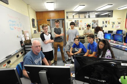 Members of the Randolph Independent School District, CyberPatriot team, discuss upcoming competition tactics during their weekly meeting Sept. 28, 2015 at Joint Base San Antonio-Randolph High School. In each of the three competition round, the team is given a virtual machine that contains several vulnerabilities and the team with the most fixes passes onto the next round, with hopes of making it to the National Championships in Washington, D.C.  CyberPatiot's goal is to excite students about Science, Technology, Engineering, and Mathematics (STEM) while giving them hands on exposure to the foundations of cyber security.