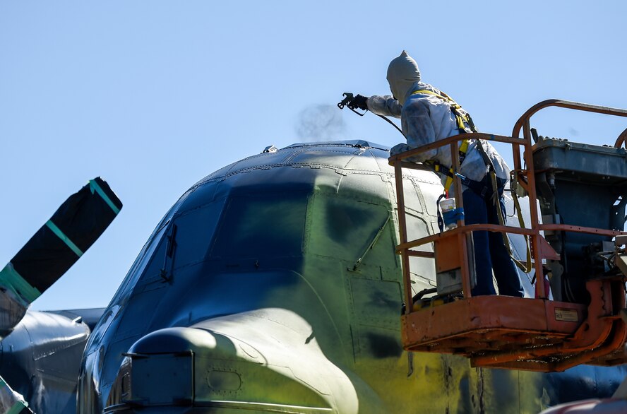 Justin Hooper, a contracted foreman, paints an MC-130 Combat Shadow for its addition to the Airpark on Hurlburt Field, Fla., Oct. 15, 2015. The 1st Special Operations Contracting Squadron negotiated, awarded and administered the contract for the painting project. (U.S. Air Force photo by Airman Kai White)