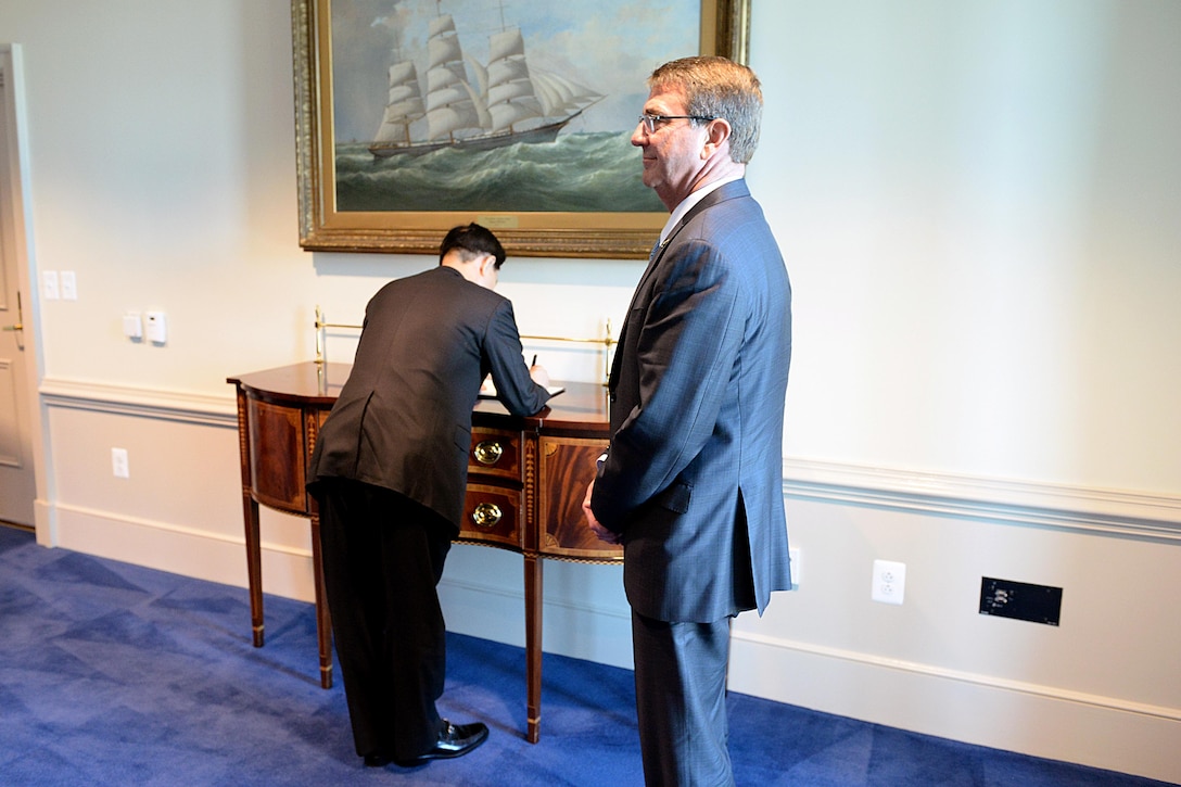 U.S. Defense Secretary Ash Carter stands by as South Korean Defense Minister Han Min-koo signs a guest book at the Pentagon, Oct. 15, 2015. DoD photo by U.S. Army Sgt. 1st Class Clydell Kinchen