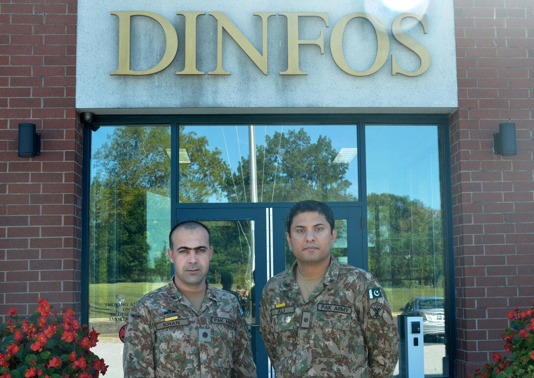 Pakistan Army Maj. Qaisar Khan and Maj. Muhammad Ali, students in the Basic Public Affairs Specialist Course at the Defense Information School on Fort Meade, Md., stand in front of the school on Oct. 6, 2015. Khan completed BPASC 070-15 on Oct. 7, and Ali is scheduled to graduate from BPASC 080-15 on Nov. 16.
